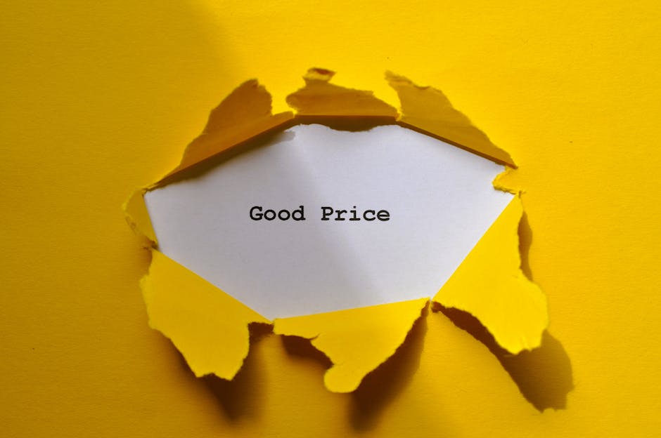 A close-up photograph of a small white card with the words 'Good Price' printed in black text, partially revealed through a tear in a piece of yellow paper. The torn edges of the paper are jagged and irregular, creating a layered effect around the card. The background is uniformly yellow, providing a vivid contrast to the white card and emphasizing the message. The image's context relates to affordable waste management or rubbish removal services, with the torn paper symbolizing the idea of uncovering or accessing hidden value in waste disposal options, subtly aligning with the theme of independent or alternative rubbish collection methods provided by waste clearance companies like Waste Clearance Pimlico.